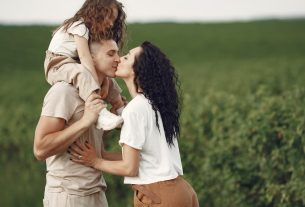 A heartwarming family moment captured in a field, highlighting love and togetherness.
